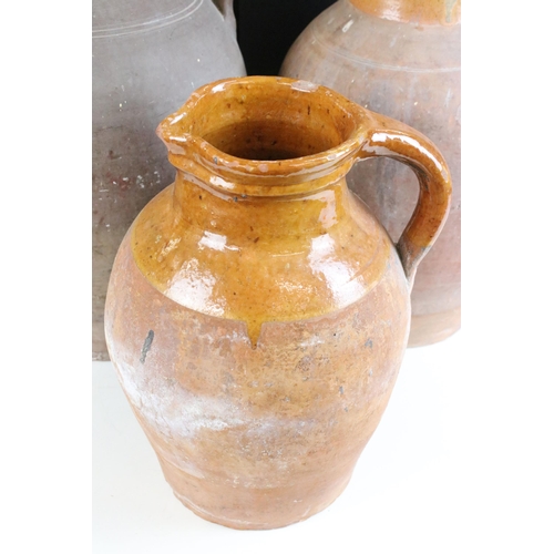 192 - Trio of large pottery harvest jugs with glazed tops, largest H 44cm, smallest H 32cm