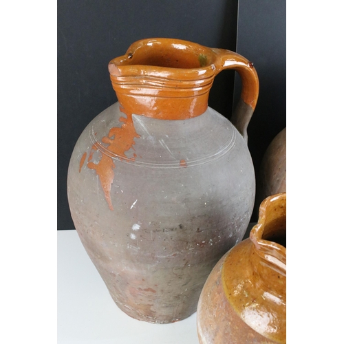 192 - Trio of large pottery harvest jugs with glazed tops, largest H 44cm, smallest H 32cm