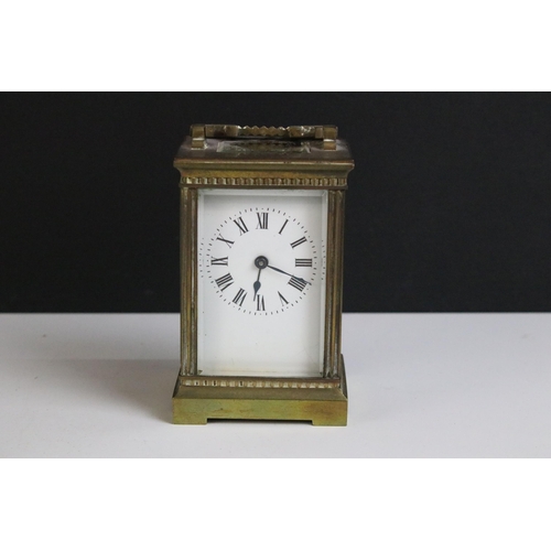 194 - Early 20th century brass carriage clock with handle H 11.5cm, W 7.5cm, D 6.5cm