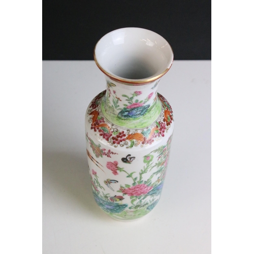 206 - Pair of famille rose vases depicting scenes of exotic birds and insects in the wild, H 25cm