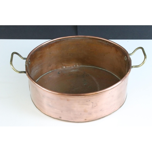 213 - Copper oval planter with twin brass loop handles, 39cm long