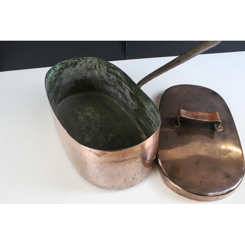 215 - 19th century copper oval saucepan with lid and cast iron handle, 33cm long