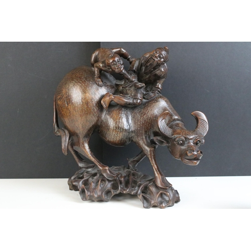 216 - Chinese carved wood sculpture of man and boy riding water buffalo on carved base, together with a Wi... 