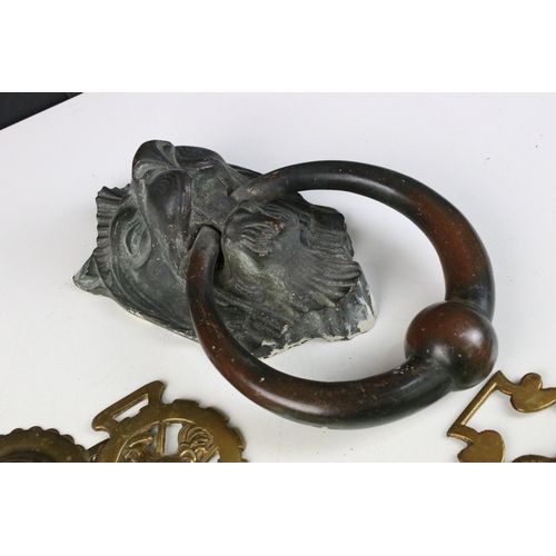 250 - WT&S cast iron lion's head mask door knocker together with a selection of horse brasses