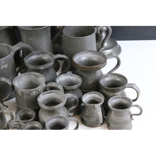 253 - Quantity of pewter items to include a pair of candlesticks, tankards of varying sizes, some with gla... 