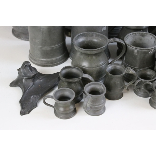 253 - Quantity of pewter items to include a pair of candlesticks, tankards of varying sizes, some with gla... 