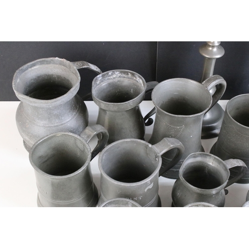 253 - Quantity of pewter items to include a pair of candlesticks, tankards of varying sizes, some with gla... 