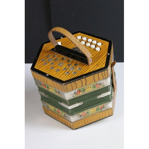 255 - German Scholer concertina, 21 buttons, with floral borders, checked lining, green bellow and decorat... 