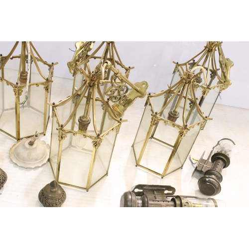 265 - Nine brass and glass hexagonal lantern light fittings with ornate wall brackets together with  a pai... 