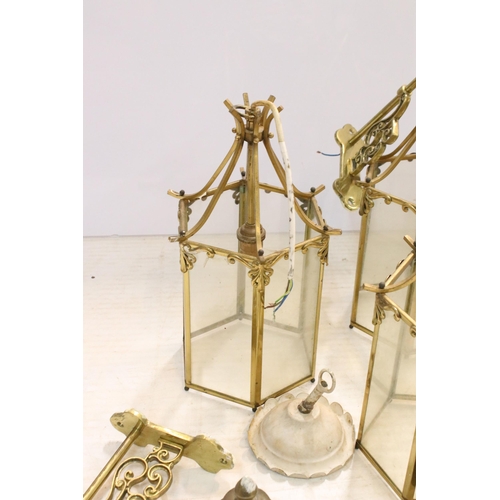 265 - Nine brass and glass hexagonal lantern light fittings with ornate wall brackets together with  a pai... 