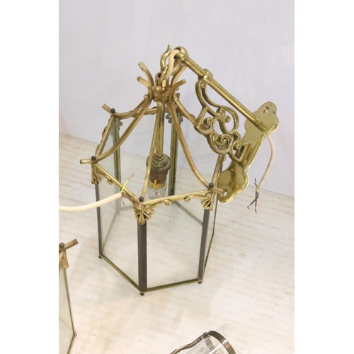 265 - Nine brass and glass hexagonal lantern light fittings with ornate wall brackets together with  a pai... 