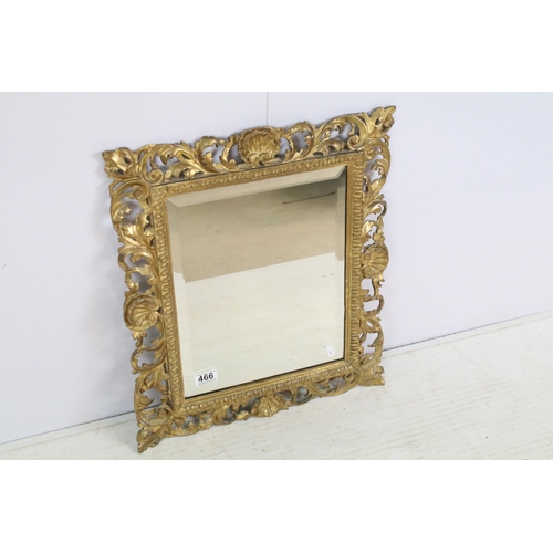 466 - Late 19th century giltwood mirror, the pierced border moulded with foliage and shells, with bevelled... 