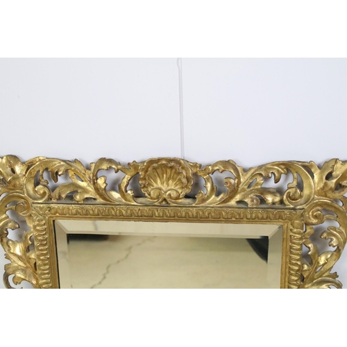 466 - Late 19th century giltwood mirror, the pierced border moulded with foliage and shells, with bevelled... 