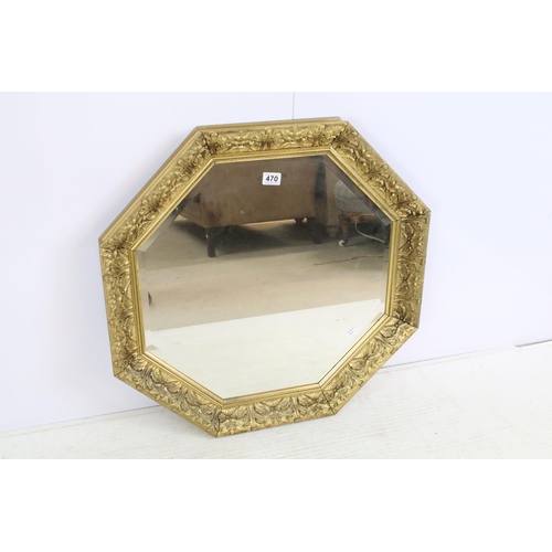 470 - 20th Century octagonal wall mirror having scrolled moulded foliate details with bevelled glass. Meas... 