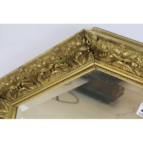 470 - 20th Century octagonal wall mirror having scrolled moulded foliate details with bevelled glass. Meas... 