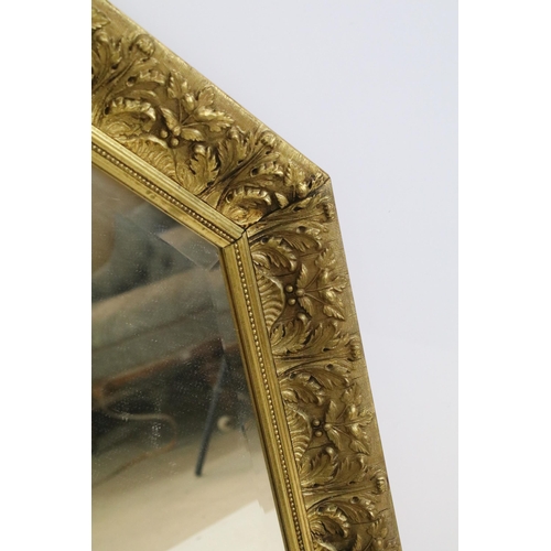 470 - 20th Century octagonal wall mirror having scrolled moulded foliate details with bevelled glass. Meas... 