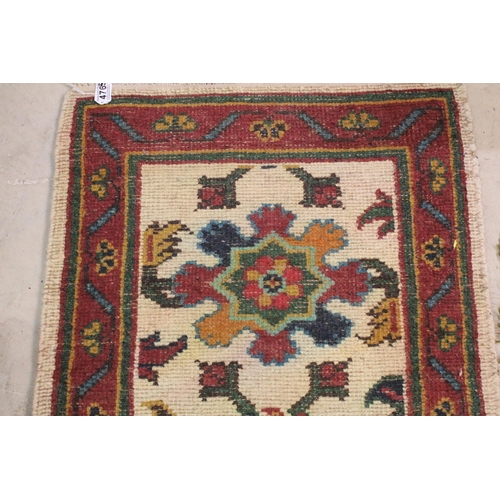 476 - Group of four rugs, one red ground example with three diamond pattern to centre, measures 124cm x 75... 