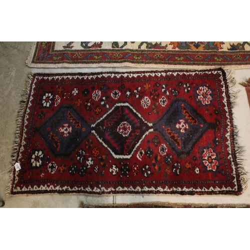 476 - Group of four rugs, one red ground example with three diamond pattern to centre, measures 124cm x 75... 