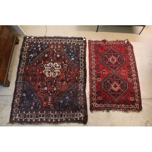 477 - Two rugs, one having blue ground with mixed colour border, burgundy diamond shape and white centre t... 