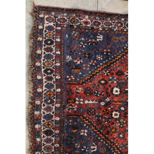 477 - Two rugs, one having blue ground with mixed colour border, burgundy diamond shape and white centre t... 