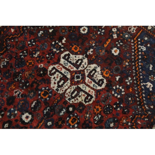 477 - Two rugs, one having blue ground with mixed colour border, burgundy diamond shape and white centre t... 