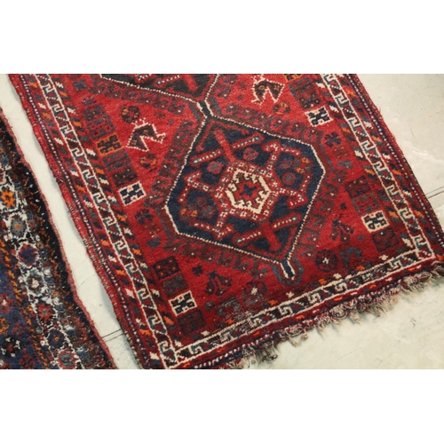 477 - Two rugs, one having blue ground with mixed colour border, burgundy diamond shape and white centre t... 