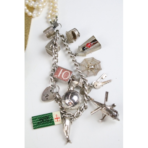 149A - Large collection of costume jewellery to include two silver charm bracelets, set of Guinness buttons... 