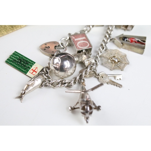 149A - Large collection of costume jewellery to include two silver charm bracelets, set of Guinness buttons... 