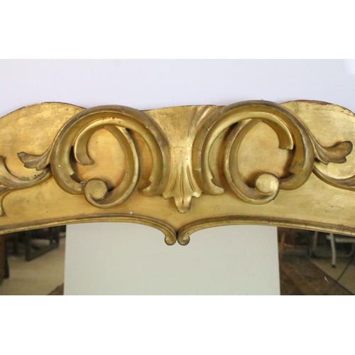 550A - Large over mantel gilded ornate footed mirror with scroll style detail to top, 92cm high, 118cm, 9cm... 