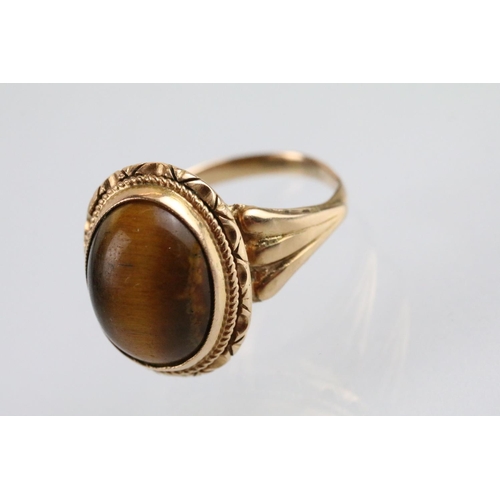 237A - Tigers eye ring and earrings jewellery suite. The lot to include a ring set with a oval tigers eye c... 