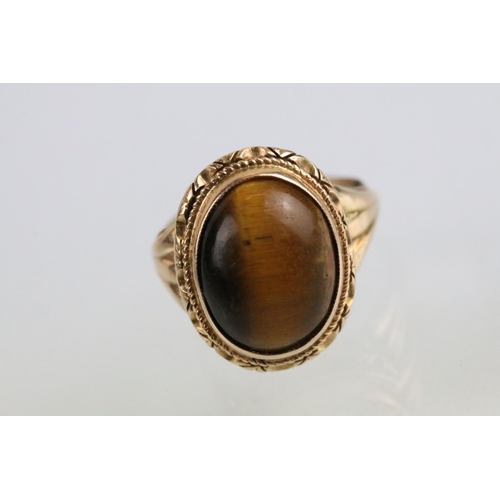 237A - Tigers eye ring and earrings jewellery suite. The lot to include a ring set with a oval tigers eye c... 