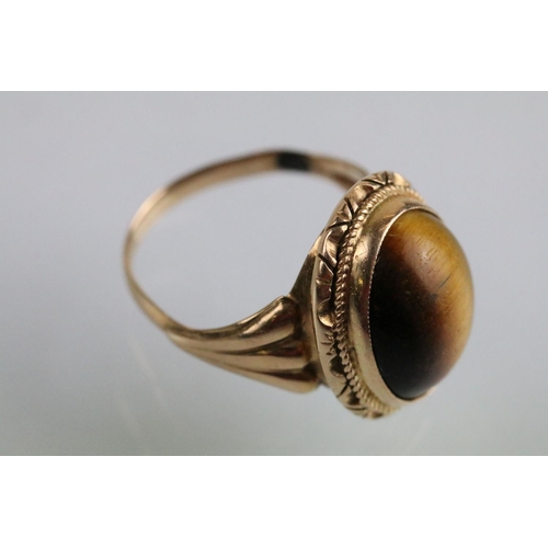 237A - Tigers eye ring and earrings jewellery suite. The lot to include a ring set with a oval tigers eye c... 