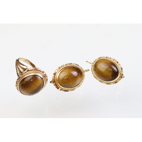 237A - Tigers eye ring and earrings jewellery suite. The lot to include a ring set with a oval tigers eye c... 