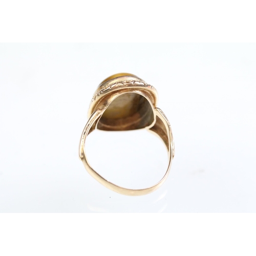 237A - Tigers eye ring and earrings jewellery suite. The lot to include a ring set with a oval tigers eye c... 