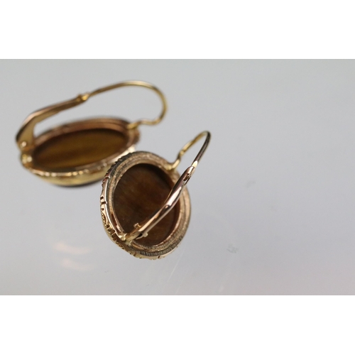 237A - Tigers eye ring and earrings jewellery suite. The lot to include a ring set with a oval tigers eye c... 