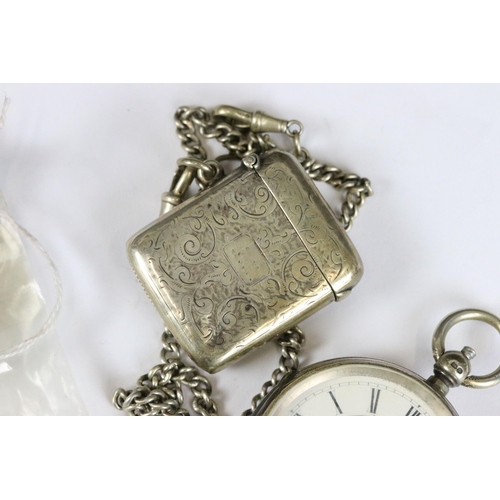 246 - Two silver cased pocket watches together with two silver albert chains and a silver vesta case.