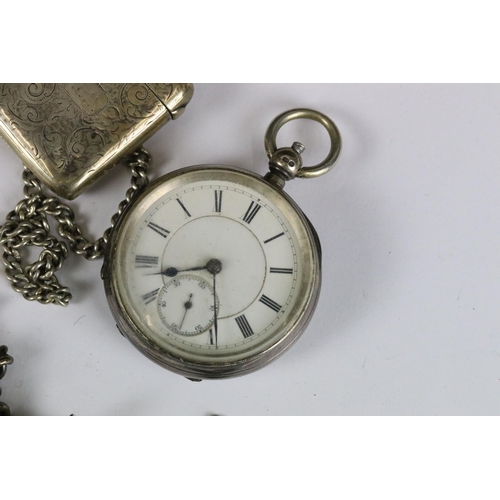 246 - Two silver cased pocket watches together with two silver albert chains and a silver vesta case.