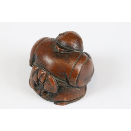 277 - A collection of Japanese carved wooden netsuke and miniature wood and resin figures.