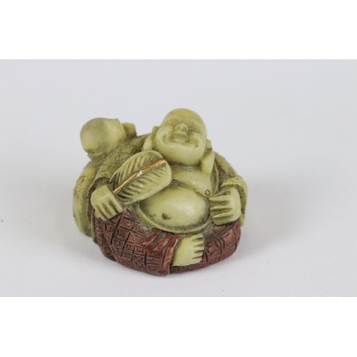 277 - A collection of Japanese carved wooden netsuke and miniature wood and resin figures.