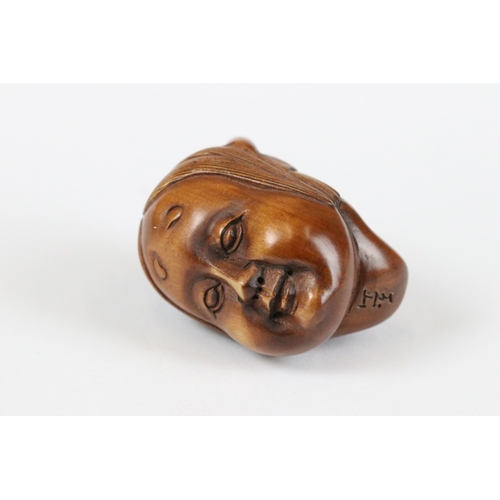 277 - A collection of Japanese carved wooden netsuke and miniature wood and resin figures.