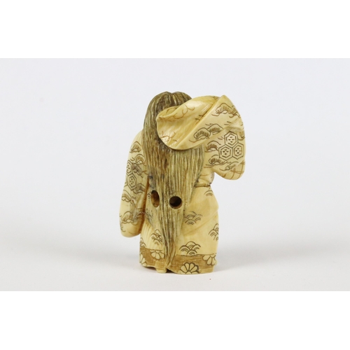 277 - A collection of Japanese carved wooden netsuke and miniature wood and resin figures.