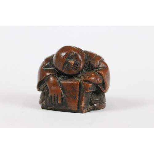 277 - A collection of Japanese carved wooden netsuke and miniature wood and resin figures.