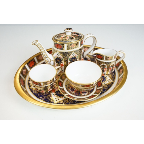 15 - Royal Derby Imari pattern 1128 miniature five piece tea set and oval tray, the tea set comprising te... 