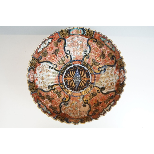 25 - Large Imari pattern scalloped gold detail bowl with decorative panels and centre butterflies, diamet... 