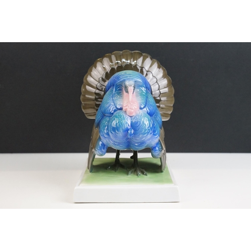 3 - Fraureuth blue painted Turkey ceramic figurine on a rectangular green plinth, marked to base, H 19cm... 