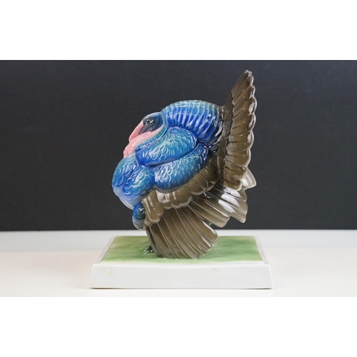 3 - Fraureuth blue painted Turkey ceramic figurine on a rectangular green plinth, marked to base, H 19cm... 