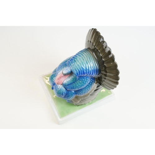 3 - Fraureuth blue painted Turkey ceramic figurine on a rectangular green plinth, marked to base, H 19cm... 