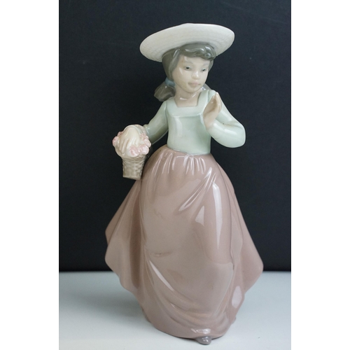 39 - Selection of figurines to include Lladro 2007 annual piece girl with bag, girl with bouquet, Nao exa... 