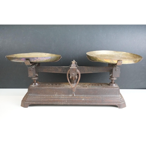 416 - Two sets of weighing scales, larger example with brass dishes and weights set on cast iron base, For... 