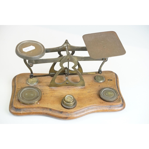 416 - Two sets of weighing scales, larger example with brass dishes and weights set on cast iron base, For... 